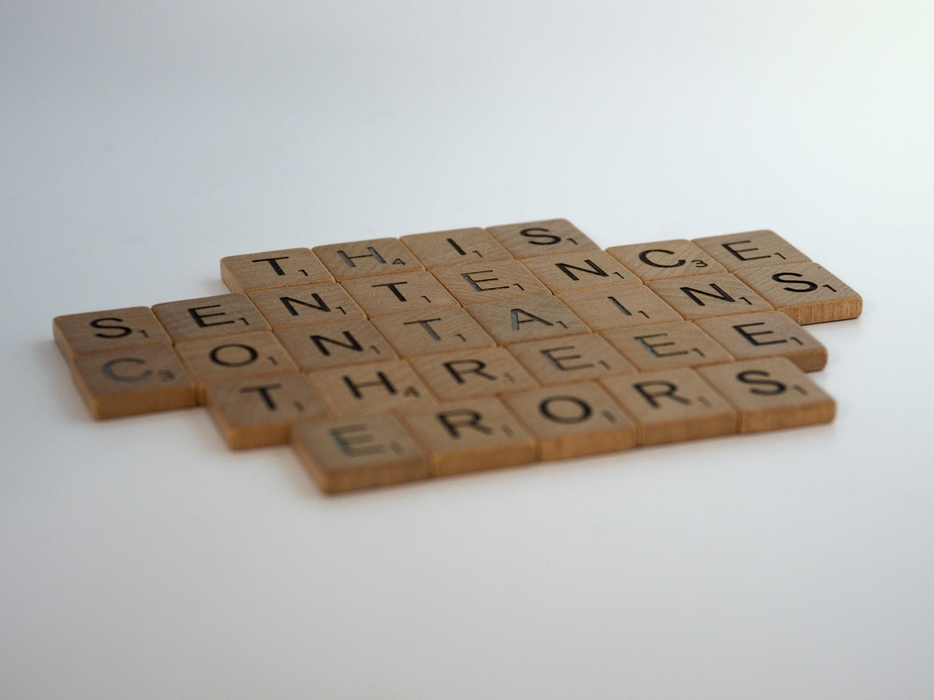Scrabble pieces showing the sentence: 
